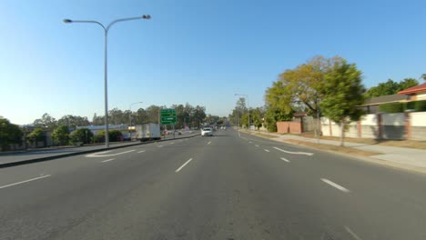 Rear-facing-driving-point-of-view-POV-of-quiet-Australian-suburban-freeway---ideal-for-interior-car-scene-green-screen-replacement