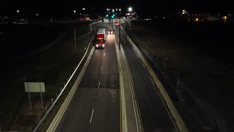 Drone-shot-of-Queen-Elizabeth-Highway-at-night-on-Glendale-Avenue,-Canada