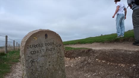 gravestone-on-a-walking-path:-durdle-door,-south-coast-of-england