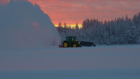 Glowing-sunrise-over-tractor-snow-blower-preparing-Norbotten-Lapland-ice-track