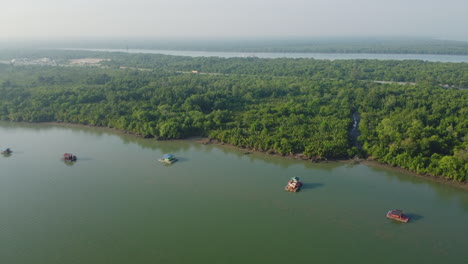 Aerial-View-of-floating-house-and-dense-forest-on-Bagan-Lalang-river,-Sepang
