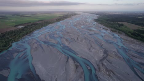 aerial-flying-over-the-braided-Waimakariri-river-with-the-Canterbury-plains-on-either-side,-Christchurch-New-Zealand