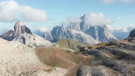 Mountain-path-below-alpine-peak-covered-in-clouds,-Monte-Pelmo-mountain,-Dolomites-landscape-aerial