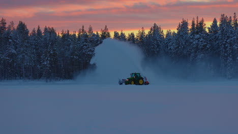 Tractor-snow-blower-clearing-Norbotten,-Sweden-woodland-ice-race-track-during-early-morning-surmise