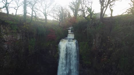 Slow-Descending-Aerial-of-Waterfall-at-Sunrise-from-the-Top-to-the-Bottom---Drone-shot-4K