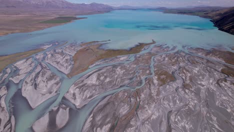 aerial-flying-over-the-braided-Godley-river-flying-towards-Lake-Tekapo-mouth-with-the-mountains-in-the-background-pt-2