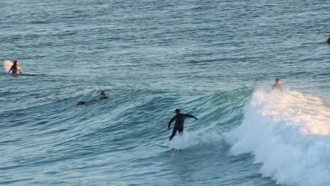 Surfer-on-blue-ocean-wave-getting-epic-barrel,-Surfing-extreme-sport,-HD-Slow-motion-in-São-Pedro,-Estoril