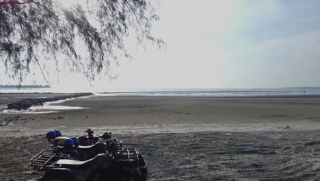 Drone-shot-of-ATV-on-the-beach-in-Bagan-Lalang-in-morning,-Selangor,-Malaysia