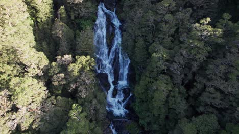 Aerial-of-Fantail-Falls-surrounded-by-rainforest-getting-closer,-West-Coast,-South-Island-in-New-Zealand