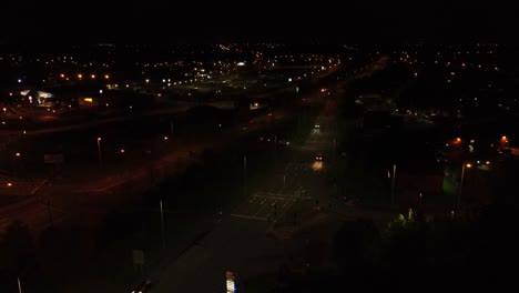Nighttime-traffic-headlights-driving-British-town-highway-roads-aerial-view