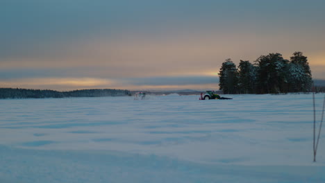 Tractor-clearing-snow-covered-drifting-track-Norbotten-Lapland-at-sunrise
