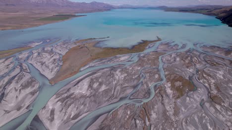 aerial-flying-over-the-braided-Godley-river-flying-towards-Lake-Tekapo-mouth-with-the-mountains-in-the-background-pt-3