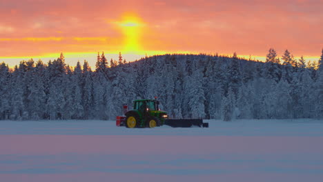 Tractor-snow-blower-clearing-Norbotten-woodland-ice-track-under-glowing-sunrise