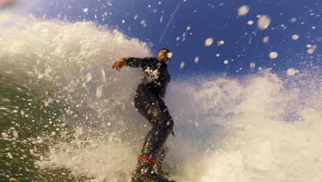 a-surfer-takes-off-and-performs-a-sweeping-roundhouse-cutback-on-a-wave-at-cascais-beach-in-slow-motion