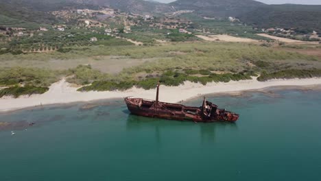 Drone-footage-of-abandoned-ship-near-the-shore-line-in-Greece