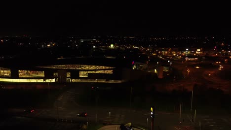 Night-traffic-headlights-driving-British-town-highway-intersection-aerial-view