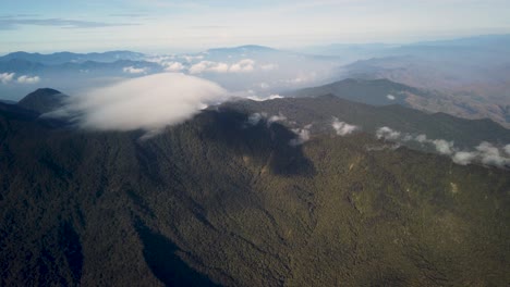 Aerial-landscape-of-forested-mountain-peaks-with-clouds,-Papua-New-Guinea