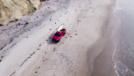 Red-lifeguard-truck-driving-down-the-Beach-in-Delmar,-drone-view,-4k