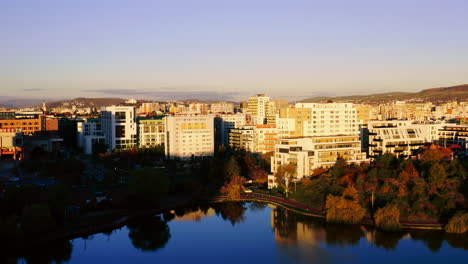 Aerial-drone-shot-over-Cluj-Napoca-city,-Iulius-mall-zone,-Iulius-park,-lake-view,-Fsega-Campus