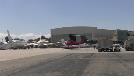 red-biplane-taxis-at-airport