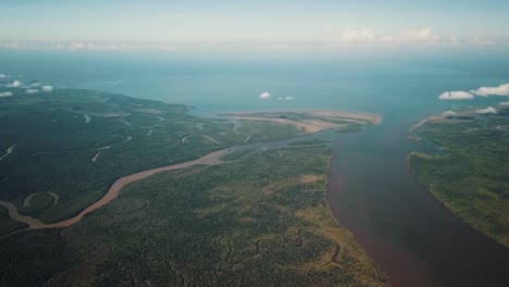 High-aerial-landscape-of-winding-rivers-emptying-into-Gulf-of-Papua,-New-Guinea