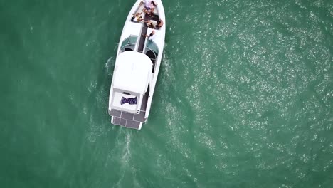 Tracking-Shot-Of-white-Boat-Cruising-In-Heart-Of-Ocean,-Callao,-Totoritas-Peru