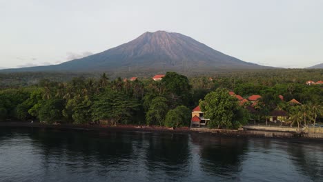 Scuba-diving-site-of-the-USAT-Liberty-Shipwreck-with-the-iconic-Mount-Agung-volcano-towering-above