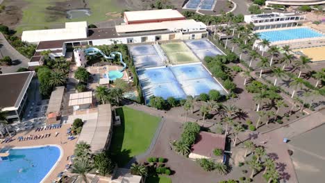 Large-tennis-courts,-swimming-pools-and-water-slides-are-seen-at-the-Playitas-Resort,-Spain