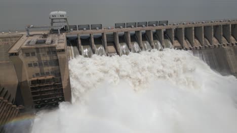 Low-aerial-approaches-hydro-dam-releasing-tons-of-water-during-flood