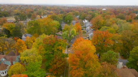 Aerial-over-street-in-suburban-neighborhood-with-gorgeous-Fall-color