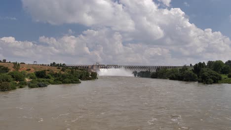 Flooding-river-below-Vaal-Dam-Wall,-S-Africa,-seen-from-highway-bridge