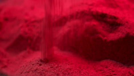 Red-sand-dropping-on-ground