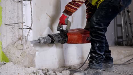 A-man-uses-a-jackhammer-on-concrete-to-break-it