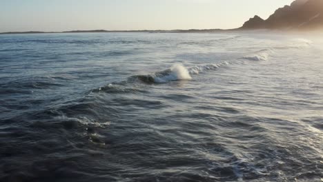 Aerial-Ocean-Shore-Waves-Breaking-Sunset,-Tracking-Right-4K