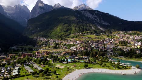 Aerial-views-of-the-Molveno-town-and-lake,-in-the-Dolomites-region,-Trento,-Italy