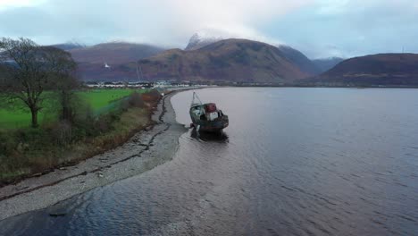 Aerial-footage-slowly-circling-and-then-closing-of-the-Corpach-shipwreck-with-Ben-Nevis-behind-on-a-clear-winter's-day