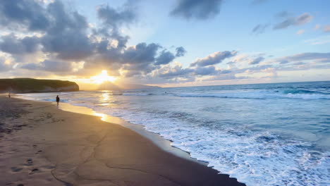 Romantic-Holiday-Scenery-with-Small-Waves-at-Sandy-Beach-during-Sunset