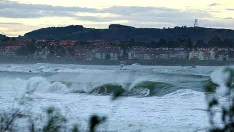 Big-waves-breaking-at-the-sea-with-city-in-background