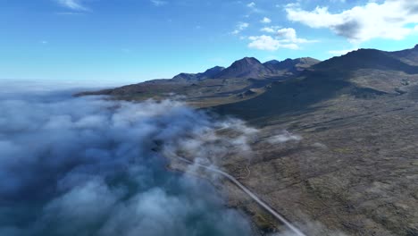 Flying-over-clouds-in-beautiful-eastern-fjord-of-Faskrudsfjordur---East-Iceland-Ring-Road