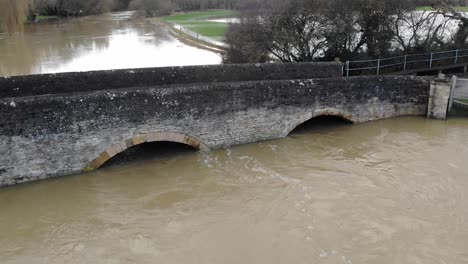 Flooded-swollen-river-under-bridge