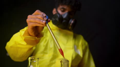 scientist-in-yellow-hazmat-suit-dropping-bloods-in-lab-tubes-for-analysis-and-studies-infection-and-virus-reaction,-chemist-wearing-respiratory-mask-working-in-laboratory-black-dark-background