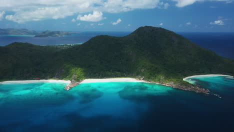Aerial-view-over-the-crystal-clear-water-on-La-Digue-Island-in-the-Seychelles,-Africa