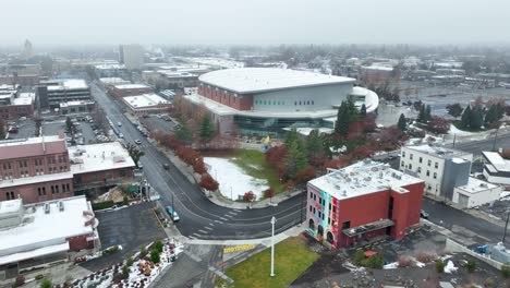 Wide-orbiting-aerial-shot-of-the-Spokane-Arena-with-buildings-surrounding-it