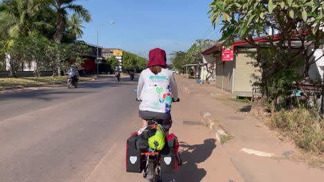 Back-view-of-women-cycling-in-the-street-of-Laos