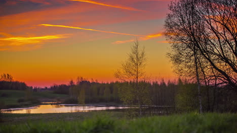 Bright-orange-sky-of-sunrise-over-the-country---Time-lapse