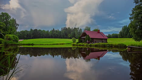 Amazing-cloudscape-above-a-cabin-by-a-picturesque-lake---day-to-night-time-lapse