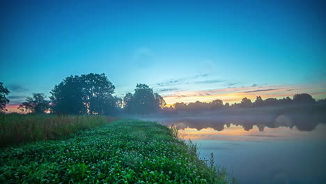 Vibrant-blue-color-of-early-misty-rural-morning-sunrise,-fusion-time-lapse