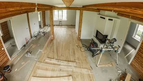 Installing-hardwood-flooring-in-a-rustic,-new-home-or-cabin---time-lapse