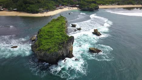 Aerial-footage-of-tropical-beach-with-coral-rocks-that-hit-by-the-wave