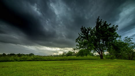 Dark-and-storm-clouds-cross-the-sky-on-a-windy-day-in-the-European-countryside---dramatic-time-lapse-cloudscape